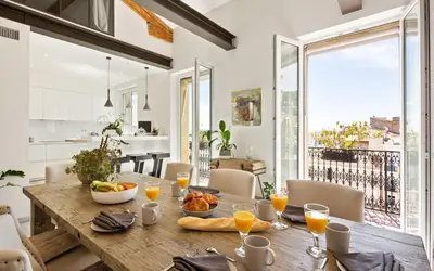 a dining room with a wooden table with food on it at Duplex ForVille in Cannes