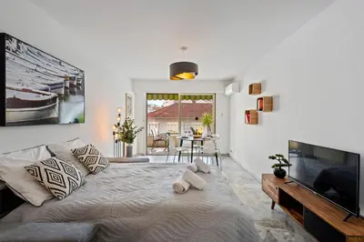 a living room with a large bed and a television at Majestic Apartment in Cannes
