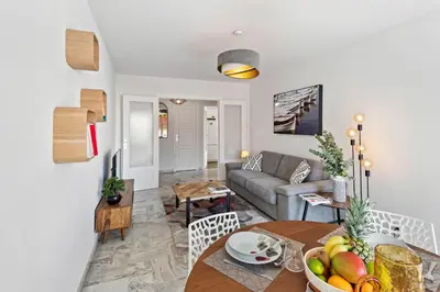 a living room with a table and a couch at Majestic Apartment in Cannes