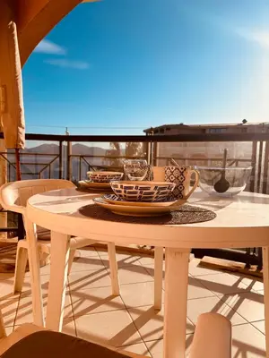a table with plates and bowls on a balcony at Résidence La Palme d'Azur - Petersen App 610 in Cannes