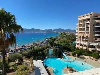 a view of the beach and a swimming pool at a resort at Résidence La Palme d'Azur - Petersen App 610 in Cannes