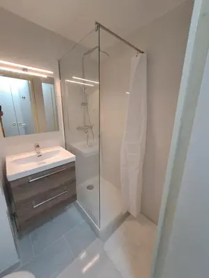 a bathroom with a glass shower and a sink at Résidence La Palme d'Azur - Petersen App 610 in Cannes
