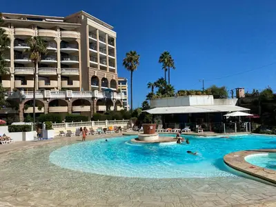 a swimming pool in front of a hotel at Résidence La Palme d'Azur - Petersen App 610 in Cannes