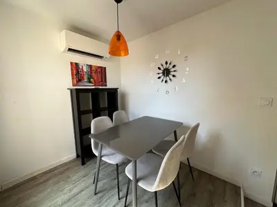 a dining room with a table and chairs at Résidence 41 Léon Noel in Cannes