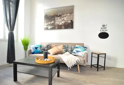 a living room with a couch and a table at Résidence 41 Léon Noel in Cannes