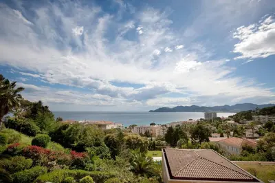 a view of a city and the ocean from a house at Appartement Wester - Welkeys in Cannes
