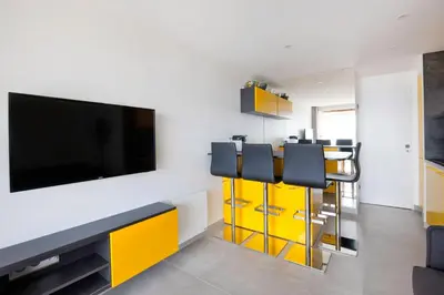 a living room with a flat screen tv on a wall at Appartement Wester - Welkeys in Cannes