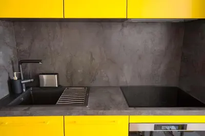 a kitchen with a sink and yellow cabinets at Appartement Wester - Welkeys in Cannes