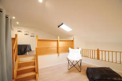 a room with a staircase and a white chair at Résidence Delattre in Cannes