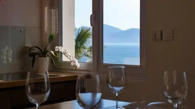 three wine glasses sitting on a table in front of a window at Plages du Midi, Superbe Vue Mer, Grand Confort, 4 pers in Cannes
