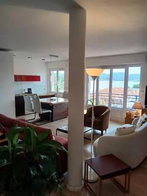 a living room with couches and chairs and a kitchen at Plages du Midi, Superbe Vue Mer, Grand Confort, 4 pers in Cannes