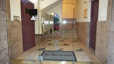 a hallway of a building with a sign on the floor at Appartement proche Croisette & Carlton By Palmazur in Cannes