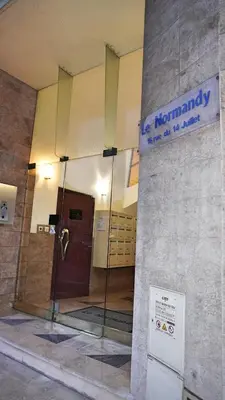 a lobby of a building with a door and a sign at Appartement proche Croisette & Carlton By Palmazur in Cannes