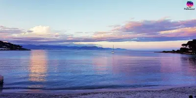 a sail boat in the water at sunset at Appartement proche Croisette & Carlton By Palmazur in Cannes