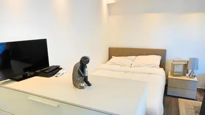 a room with a television and a statue on a desk at Appartement proche Croisette & Carlton By Palmazur in Cannes