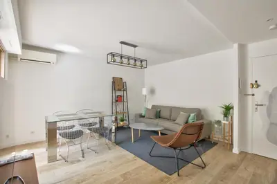 a living room with a couch and a table at MAR2 - Beau 2 pièces avec loggia fermée et aménagée en centre ville in Cannes