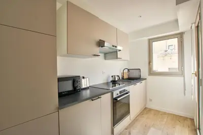 a kitchen with a sink and a microwave at MAR2 - Beau 2 pièces avec loggia fermée et aménagée en centre ville in Cannes