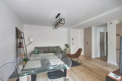 a living room with a table and a couch at MAR2 - Beau 2 pièces avec loggia fermée et aménagée en centre ville in Cannes