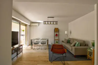 a living room with a couch and a table at MAR2 - Beau 2 pièces avec loggia fermée et aménagée en centre ville in Cannes