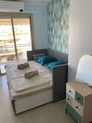 a bedroom with a bed with two pillows on it at Appartement rooftop, première ligne, vue mer, 50m de plage du Midi in Cannes