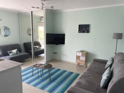 a living room with a couch and a table at Appartement rooftop, première ligne, vue mer, 50m de plage du Midi in Cannes