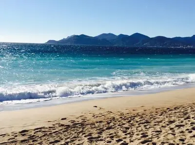 a beach with footprints in the sand and the ocean at Appartement rooftop, première ligne, vue mer, 50m de plage du Midi in Cannes
