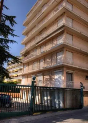 a tall building with a fence in front of it at Appartement rooftop, première ligne, vue mer, 50m de plage du Midi in Cannes