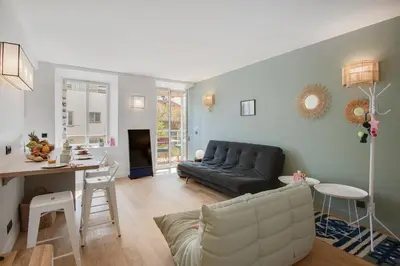 a living room with a couch and a table at Gold Apartment in Cannes