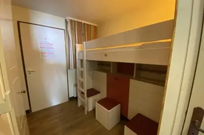 a small room with a bunk bed with a door at C021 Lumineux appartement avec Terrasse et Piscine in Cannes