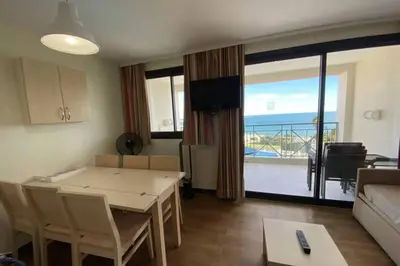 a living room with a table and a room with a view at C021 Lumineux appartement avec Terrasse et Piscine in Cannes