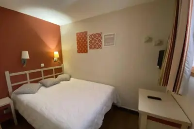 a bedroom with a white bed and a desk at C021 Lumineux appartement avec Terrasse et Piscine in Cannes