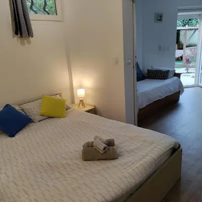 a bedroom with a bed with a stuffed animal on it at Idéal pied à terre proche Cannes & Sophia, parking in Mougins