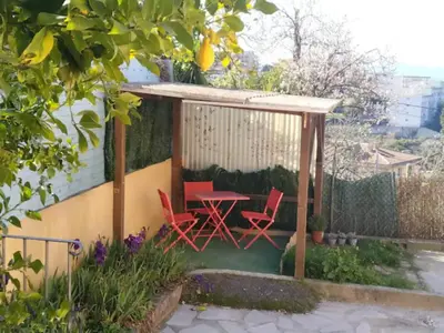 a gazebo with a table and chairs in a garden at Idéal pied à terre proche Cannes & Sophia, parking in Mougins