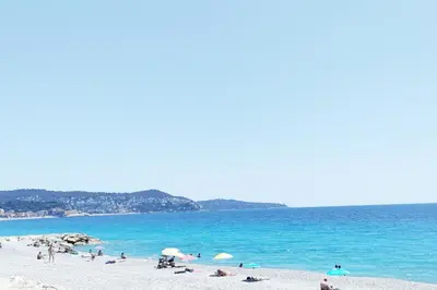 a group of people on a beach near the water at Idéal pied à terre proche Cannes & Sophia, parking in Mougins