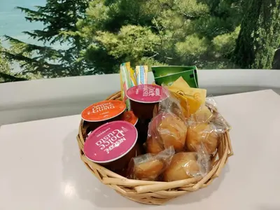 a basket filled with jam and snacks on a table at Idéal pied à terre proche Cannes & Sophia, parking in Mougins