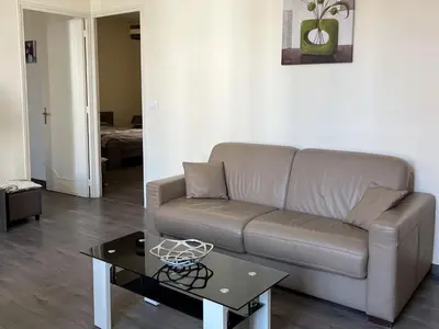 a living room with a couch and a coffee table at Cannes Centre, 3 Chambres, Plage et La Croisette à 50m in Cannes