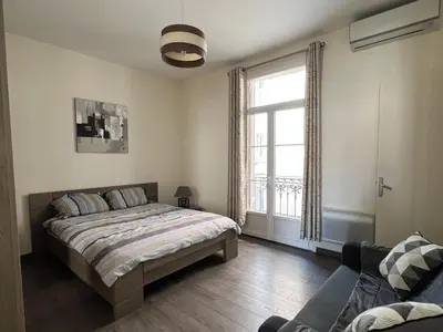 a bedroom with a bed and a large window at Cannes Centre, 3 Chambres, Plage et La Croisette à 50m in Cannes
