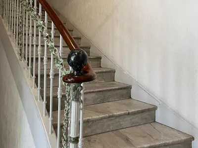 a stairway with a wooden rail and a spiral staircase at Cannes Centre, 3 Chambres, Plage et La Croisette à 50m in Cannes