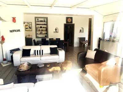 a living room with a couch and a table at Cannes Charming Villa Private Pool near beaches new award 10 out of 10 in Le Cannet
