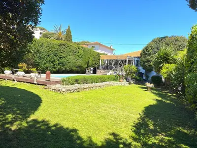 a yard with a house and a pool and grass at Cannes Charming Villa Private Pool near beaches new award 10 out of 10 in Le Cannet