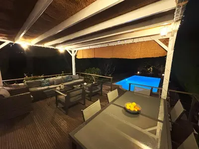 a patio with a table and a couch and a table at Cannes Charming Villa Private Pool near beaches new award 10 out of 10 in Le Cannet