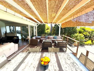 an outdoor patio with a table with fruit on it at Cannes Charming Villa Private Pool near beaches new award 10 out of 10 in Le Cannet