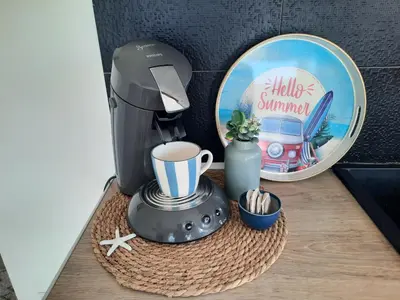 a coffee maker on a table next to a mirror at Studio Croix des Gardes Palais Plages in Cannes