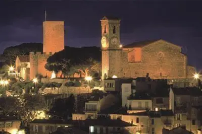 a large building with a clock tower at night at Studio Croix des Gardes Palais Plages in Cannes