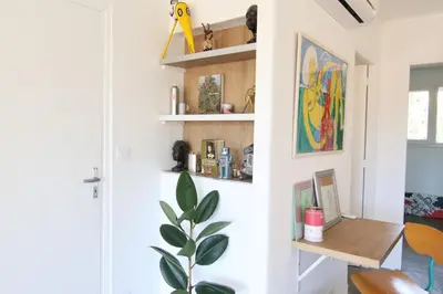 a room with white walls and a desk and a plant at Sunset Loft in Cannes