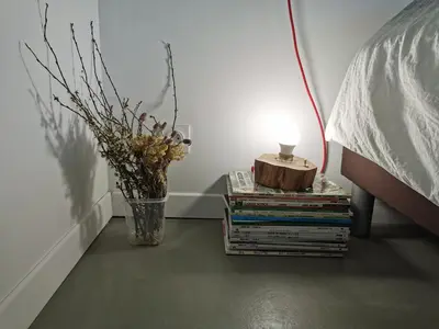 a table with a stack of books next to a bed at Sunset Loft in Cannes