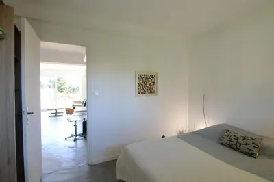 a bedroom with a bed and a desk in a room at Sunset Loft in Cannes