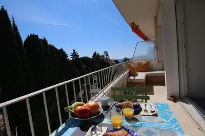 a table with a bowl of fruit on a balcony at Sunset Loft in Cannes