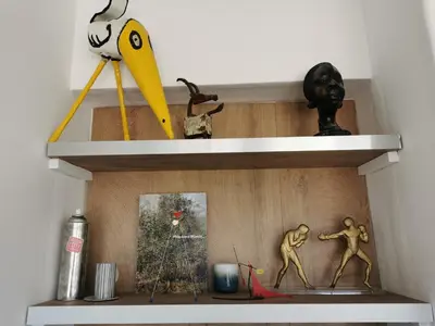 a shelf with some figurines on it at Sunset Loft in Cannes