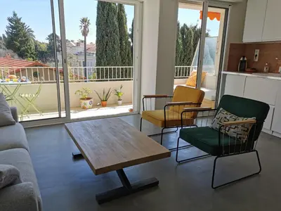 a living room with a coffee table and chairs at Sunset Loft in Cannes
